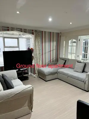 a living room with two couches and a tv at On The Beach Apartments in Blackpool