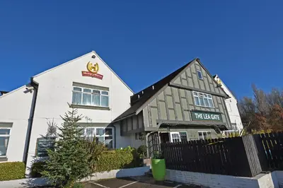 a large white building with a meerkat sign on it at Lea Gate by Greene King Inns in Preston