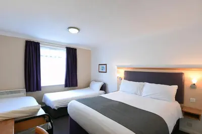 a hotel room with two beds and a window at Lea Gate by Greene King Inns in Preston