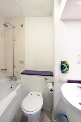 a white bathroom with a toilet and a sink at Lea Gate by Greene King Inns in Preston