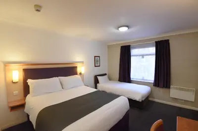 a hotel room with two beds and a window at Lea Gate by Greene King Inns in Preston