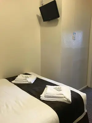 a hotel room with two towels on a bed at The Feathers Hotel in Blackpool