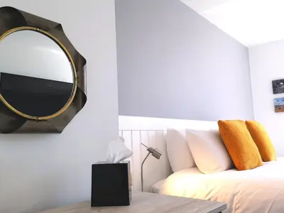 a bedroom with a bed with a mirror on the wall at Mode Hotel Lytham in Lytham St Annes