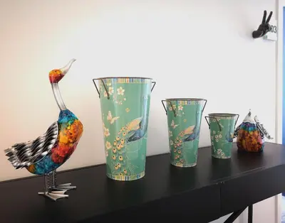 four colorful glass vases sitting on a table at Mode Hotel Lytham in Lytham St Annes