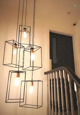 a chandelier hanging over a staircase with a door at Mode Hotel Lytham in Lytham St Annes
