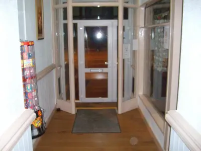 a hallway with an open door and a hallway sidx sidx sidx at Maples Hotel in Blackpool