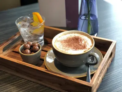 a wooden tray with a cup of coffee on a table at Crowne Plaza Liverpool City Centre by IHG in Liverpool