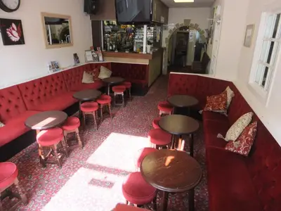 an overhead view of a bar with red chairs and tables at Charnley Gold in Blackpool