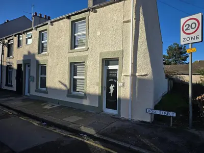 a building with a speed limit sign in front of it at Eden Rose Cottage hot-tub jacuzzi morecambe-bay in Morecambe