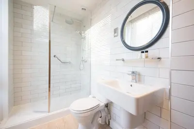 a bathroom with a sink and a toilet and a mirror at All Bar One by Innkeeper's Collection in Liverpool