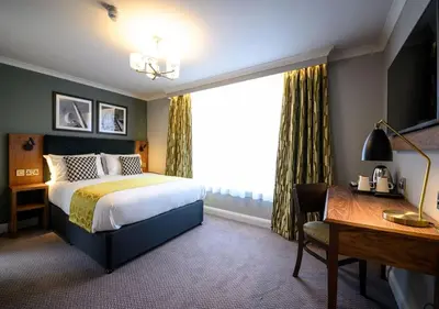 a hotel room with a bed and a desk and a window at All Bar One by Innkeeper's Collection in Liverpool