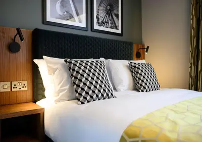 a bedroom with a bed with black and white pillows at All Bar One by Innkeeper's Collection in Liverpool