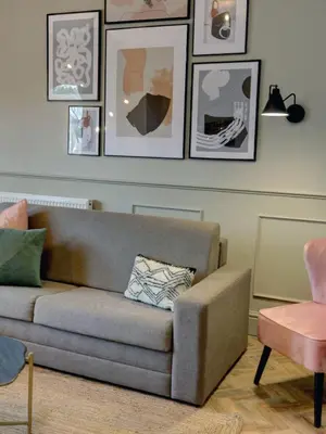 a living room with a couch and pictures on the wall at Hy Lytham St Anne's in Lytham St Annes