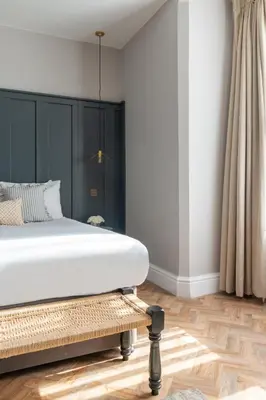 a bedroom with a white bed and a wooden floor at Hy Lytham St Anne's in Lytham St Annes