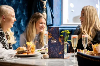 a group of women sitting at a table with food at The Dixie Dean Hotel in Liverpool