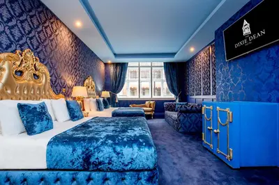 a hotel room with a king sized bed and a couch at The Dixie Dean Hotel in Liverpool