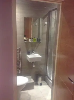 a bathroom with a sink and a toilet at The Anfield Apartment in Liverpool
