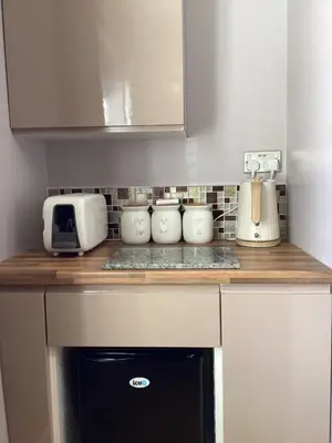 a kitchen with a counter with a toaster and a microwave at The Anfield Apartment in Liverpool