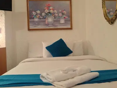 a white bed with towels on top of it at Wilsons Hotel - Blackpool Tower View in Blackpool