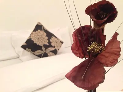 a bunch of red flowers on a bed at Wilsons Hotel - Blackpool Tower View in Blackpool