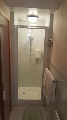 a bathroom with a shower with a glass door at The Kimberley B&B in Blackpool