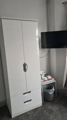 a white cabinet with a tv on top of it at The Kimberley B&B in Blackpool