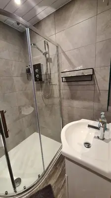 a bathroom with a shower and a sink at The Kimberley B&B in Blackpool