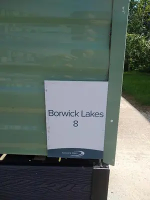 a sign on the side of a green bus at Borwick Lakes Haven in Burton