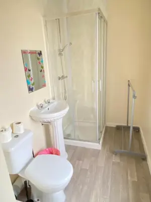 a bathroom with a shower and a toilet and a sink at Chilton Hotel in Blackpool