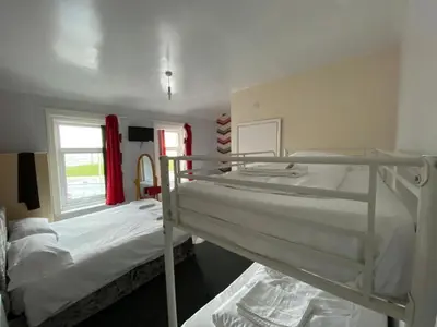 a bedroom with two bunk beds and a window at Chilton Hotel in Blackpool