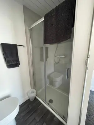a bathroom with a shower and a toilet at Harleys Reads Avenue in Blackpool