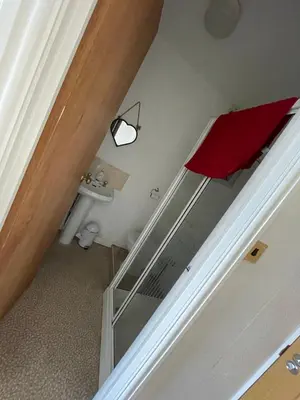 a stairway with a red towel and a mirror at Harleys Reads Avenue in Blackpool
