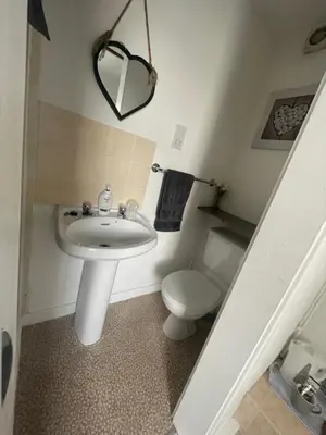 a bathroom with a sink and a toilet at Harleys Reads Avenue in Blackpool