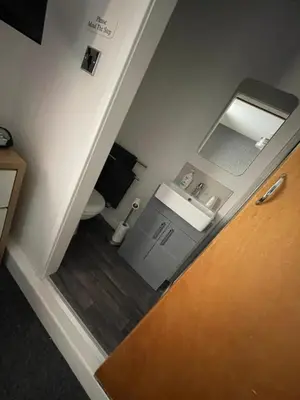 a small bathroom with a sink and a toilet at Harleys Reads Avenue in Blackpool