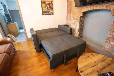 a living room with a couch and a fireplace at Urban Apartment Free Parking Near Pleasure Beach in Blackpool