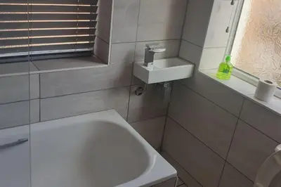 a bathroom with a sink and a white bath tub at Urban Apartment Free Parking Near Pleasure Beach in Blackpool