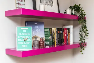 a pink book shelf with books on it at Host & Stay - York Place Apt in Liverpool