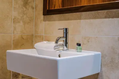 a white sink with a faucet in a bathroom at Host & Stay - Waterfront View in Liverpool