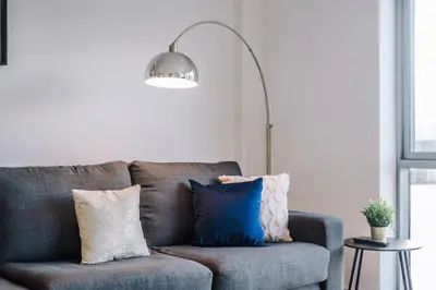 a living room with a gray couch with pillows at Host & Stay - Waterfront View in Liverpool