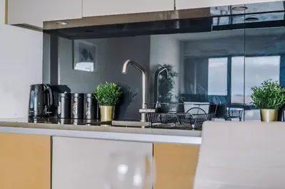 a kitchen with a sink and some plants on the counter at Host & Stay - Waterfront View in Liverpool