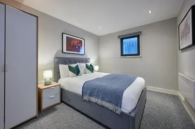 a bedroom with a large bed and two windows at Host & Stay - Ropewalks Abode in Liverpool