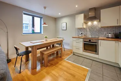 a kitchen with a wooden table and a dining room at Host & Stay - Ropewalks Abode in Liverpool