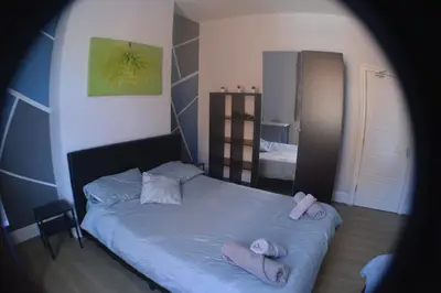 a bedroom with a bed with towels on it at Kensington Guest House Liverpool in Liverpool
