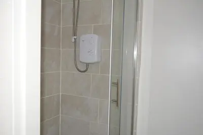 a shower with a soap dispenser in a bathroom at Kensington Guest House Liverpool in Liverpool