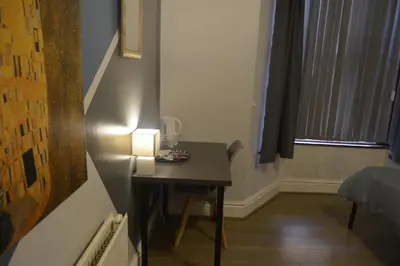a room with a small table with a lamp on it at Kensington Guest House Liverpool in Liverpool