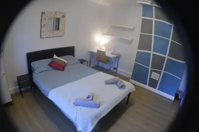 a bedroom with a bed with two towels on it at Kensington Guest House Liverpool in Liverpool