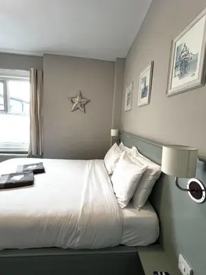 a bedroom with a bed with a star on the wall at Central Cove Guesthouse in Blackpool