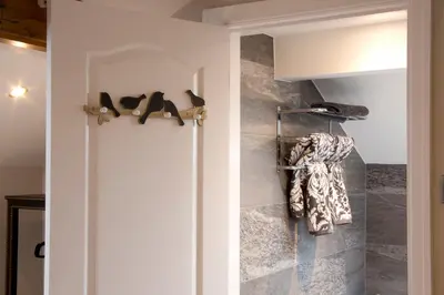 a bathroom with a closet with shoes on a wall at Blackbird Luxury Apartments Room 4 in Blackpool