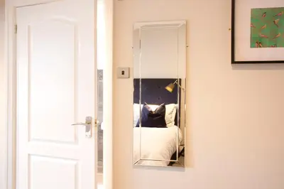 a mirror on a wall next to a door at Blackbird Luxury Apartments Room 4 in Blackpool