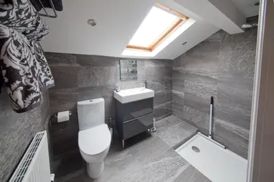 a bathroom with a toilet and a sink and a window at Blackbird Luxury Apartments Room 4 in Blackpool